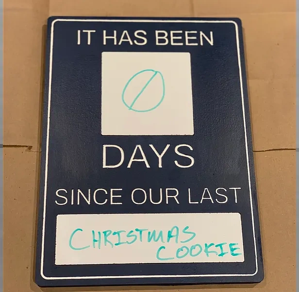 Painted incident-counter sign with whiteboard panels for a day count and incident description